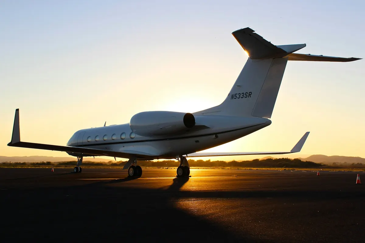 Business jet on a runway at sunset