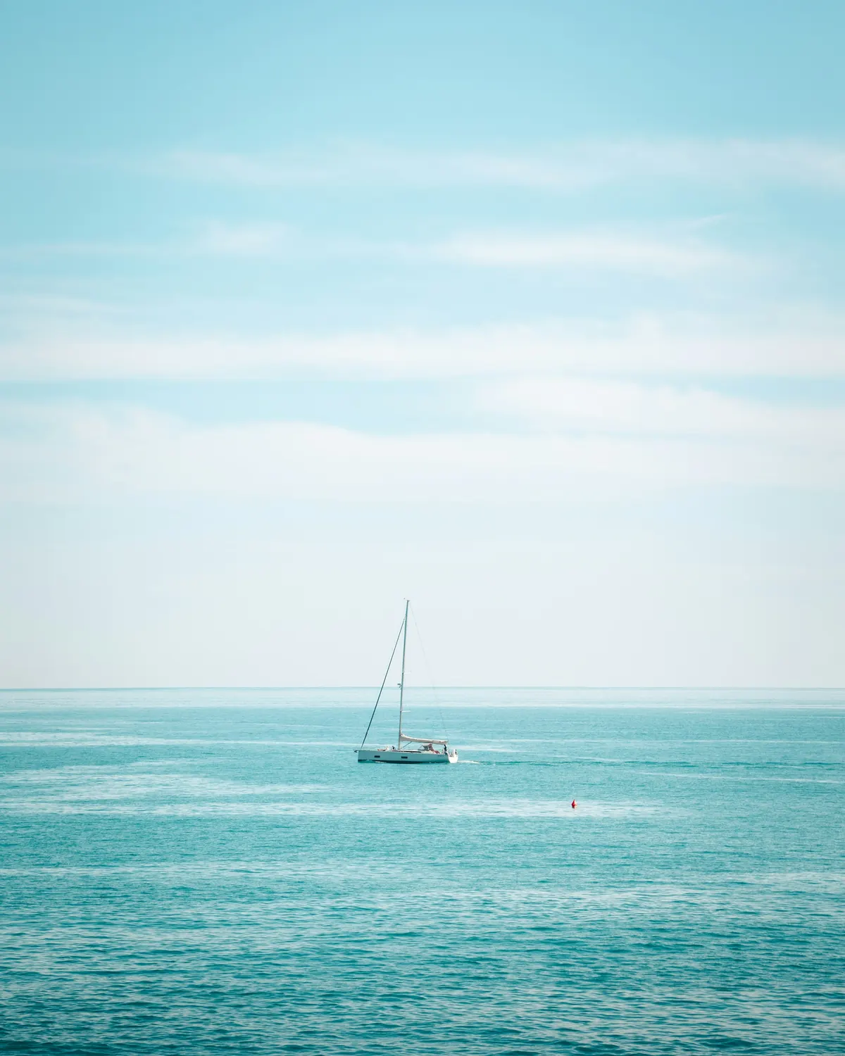 Sailing boat on a calm turquoise sea